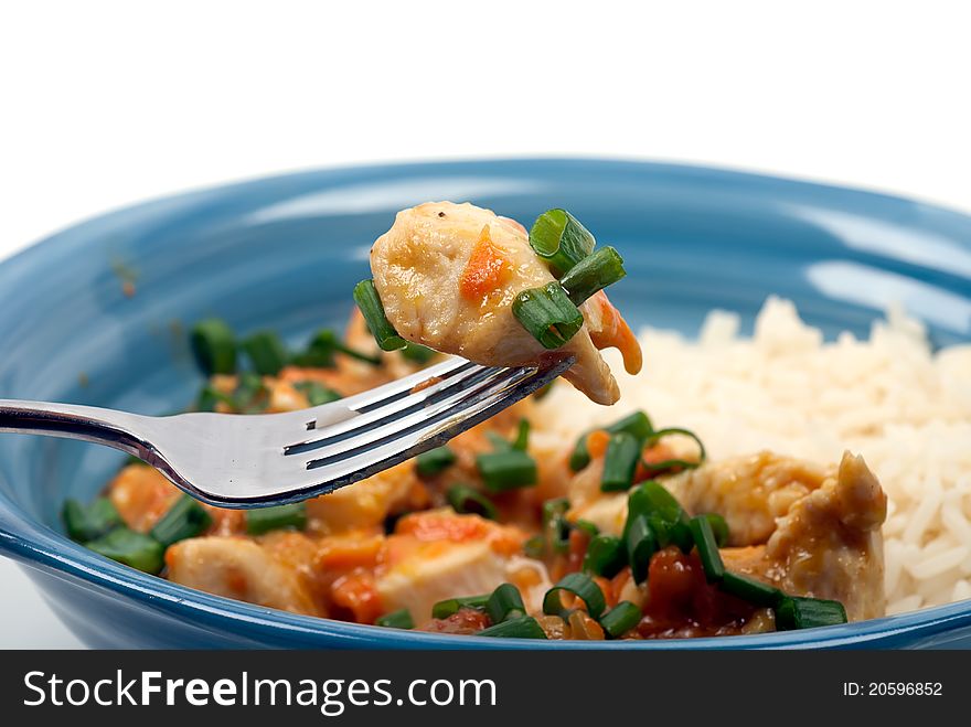 Studio shot of Peanut butter chicken and rice meal on white background