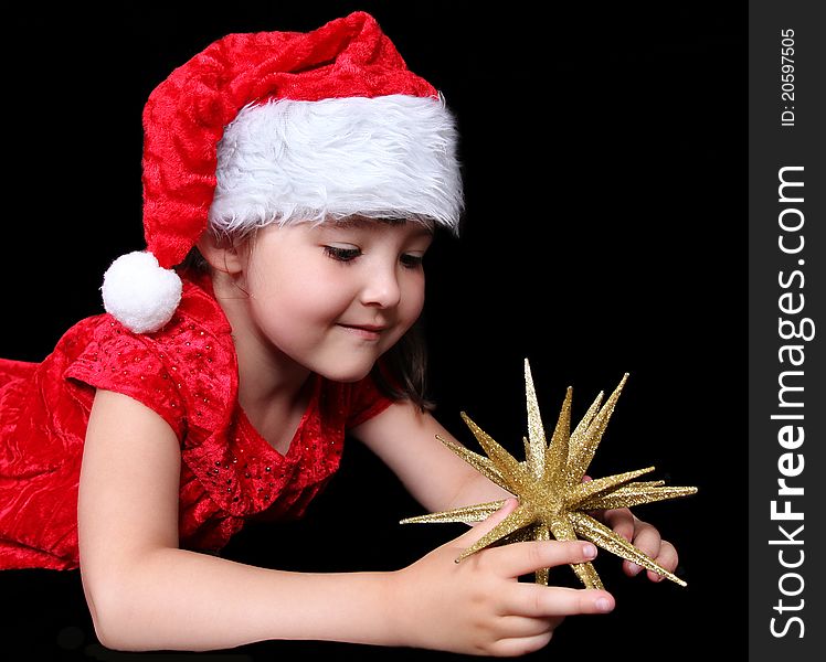 Girl In Christmas Outfit Playing With Golden Star