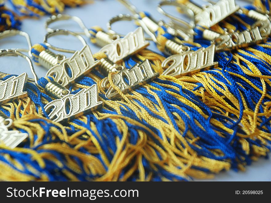 Golden and blue 2011 graduation tassels