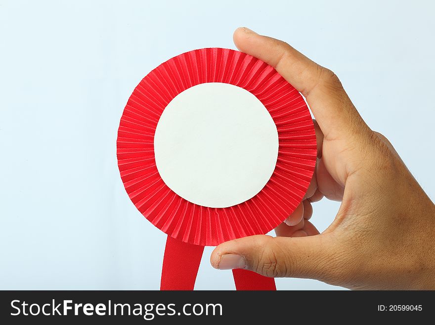 Reward red sign in a hand on white background. Reward red sign in a hand on white background