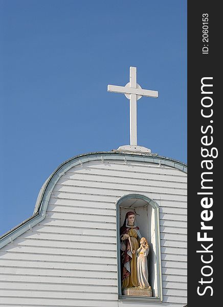 This is the top of the St. Anne mission showing the statues and cross