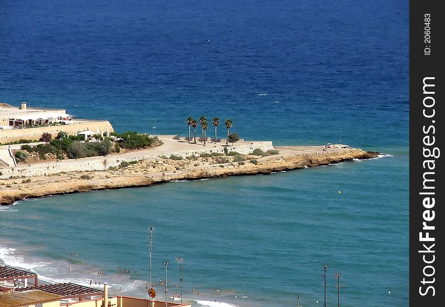 Urban beach on Mediterranian Sea protected by a long cape