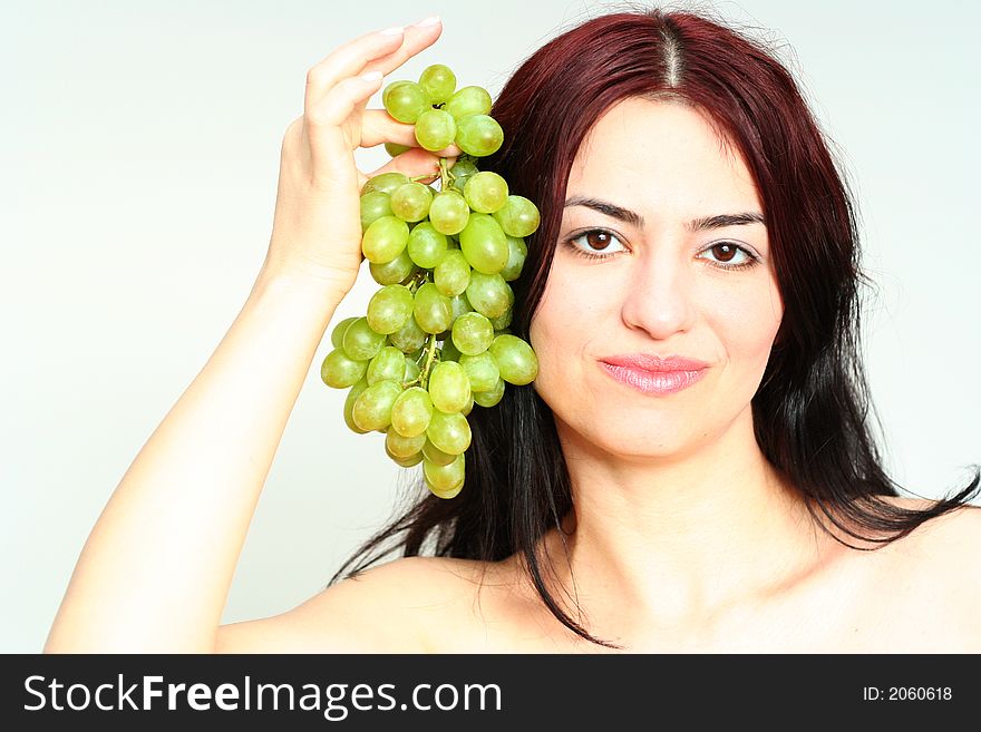 Oriental pretty girl give the grape in a hand. Oriental pretty girl give the grape in a hand