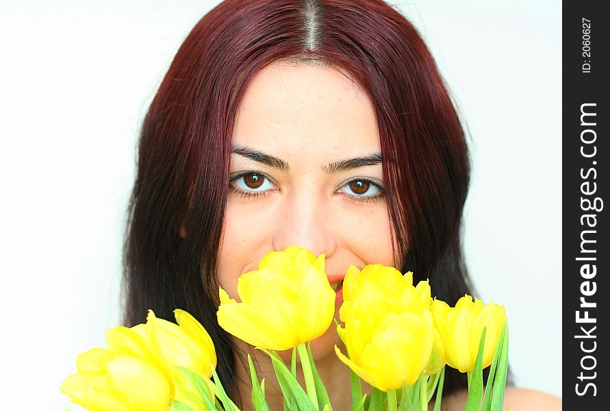 Oriental pretty girl cached in the yellow tulips. Oriental pretty girl cached in the yellow tulips