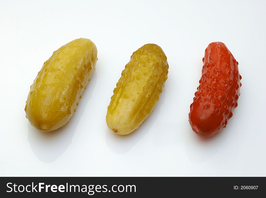 Three cucumbers over white background. Conceptual photo - difference.