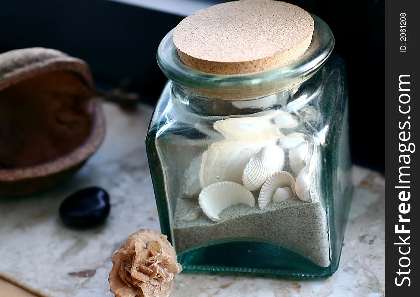 Still life with shells in glass, sand-rose, buddhanut. Still life with shells in glass, sand-rose, buddhanut