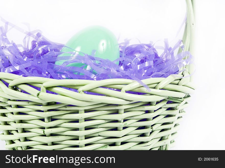 Chocolate easter candy hidden amongst purple hay in basket. Chocolate easter candy hidden amongst purple hay in basket