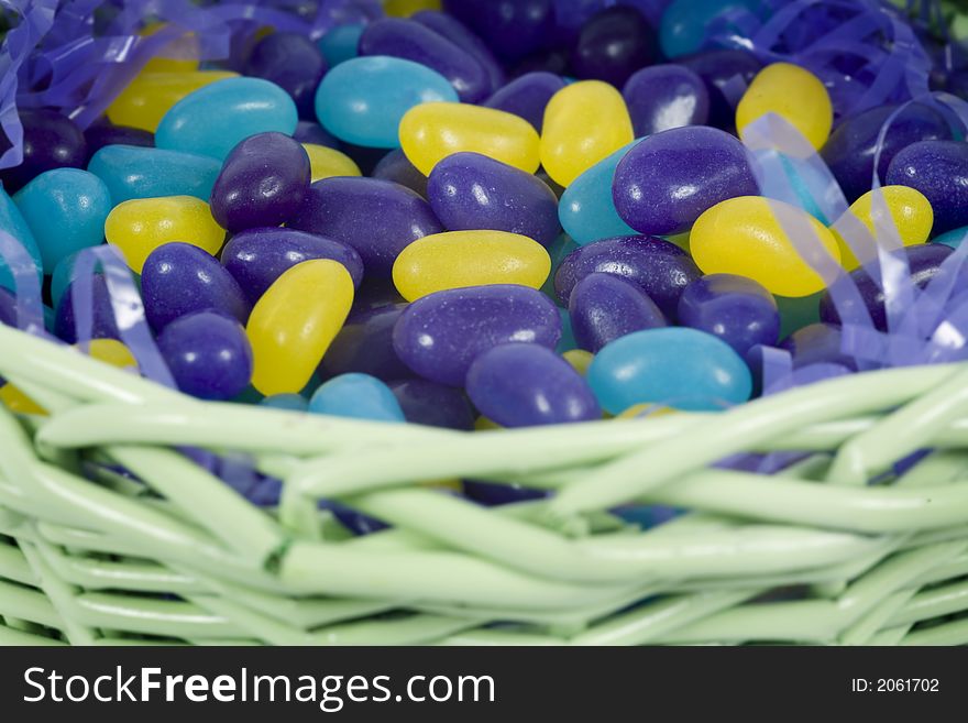 Chocolate easter candy hidden amongst purple hay in basket. Chocolate easter candy hidden amongst purple hay in basket