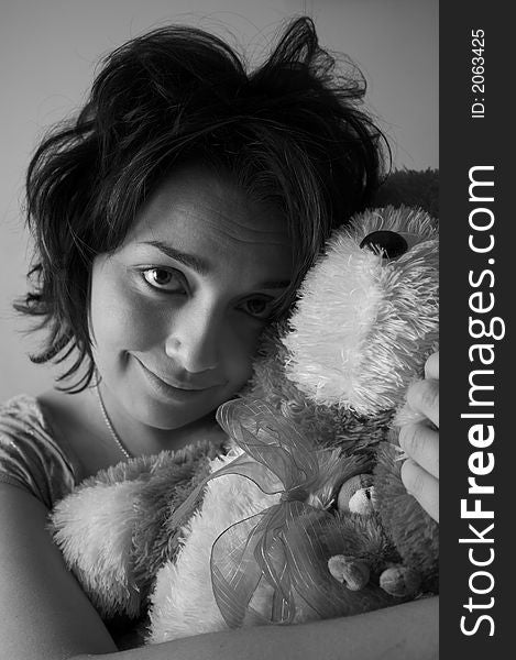 Young brunete girl with her toy bear. Young brunete girl with her toy bear