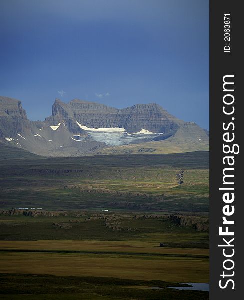 Across the fields to Dyrfjoll mountain Iceland