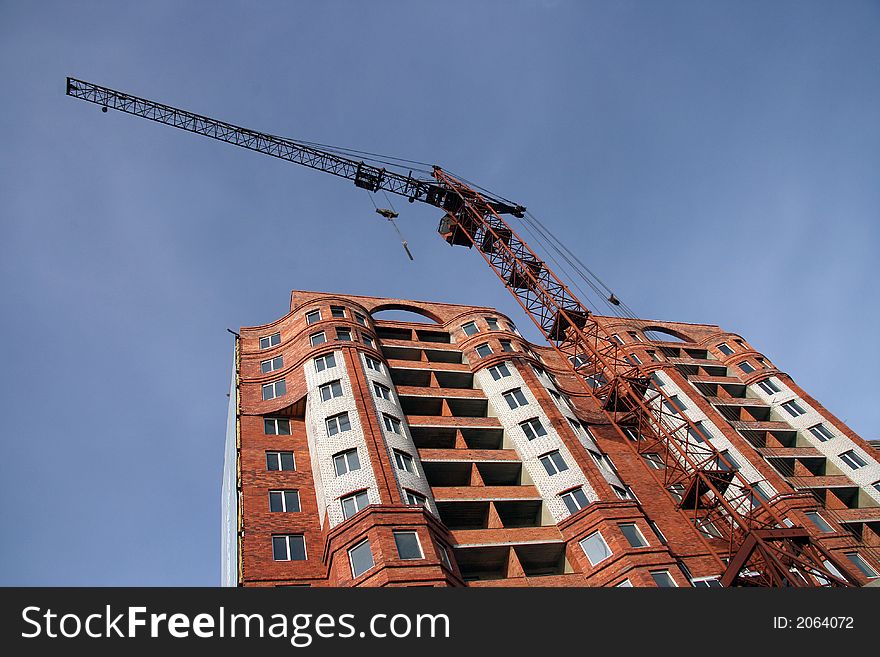 Construction of a new multi-storey brick building with the lift in the foreground. Construction of a new multi-storey brick building with the lift in the foreground.