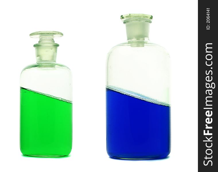 Closer view at laboratory bottles with green and blue liquid. Closer view at laboratory bottles with green and blue liquid