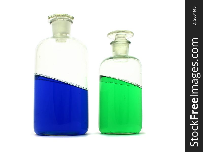 Laboratory bottles with tilted colourful liquid