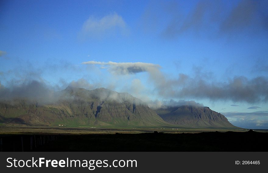 Clouds over hanging over the tops of the mountains Iceland. Clouds over hanging over the tops of the mountains Iceland