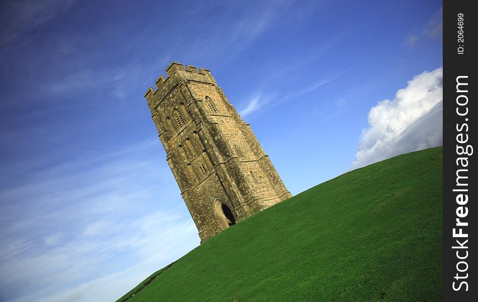 Quirky angle of Glastonbury Tor against a blue sky