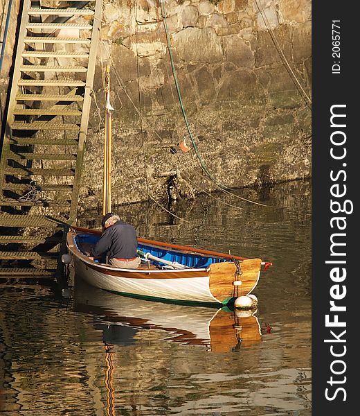 Lonely fisherman in a boat, Basque country