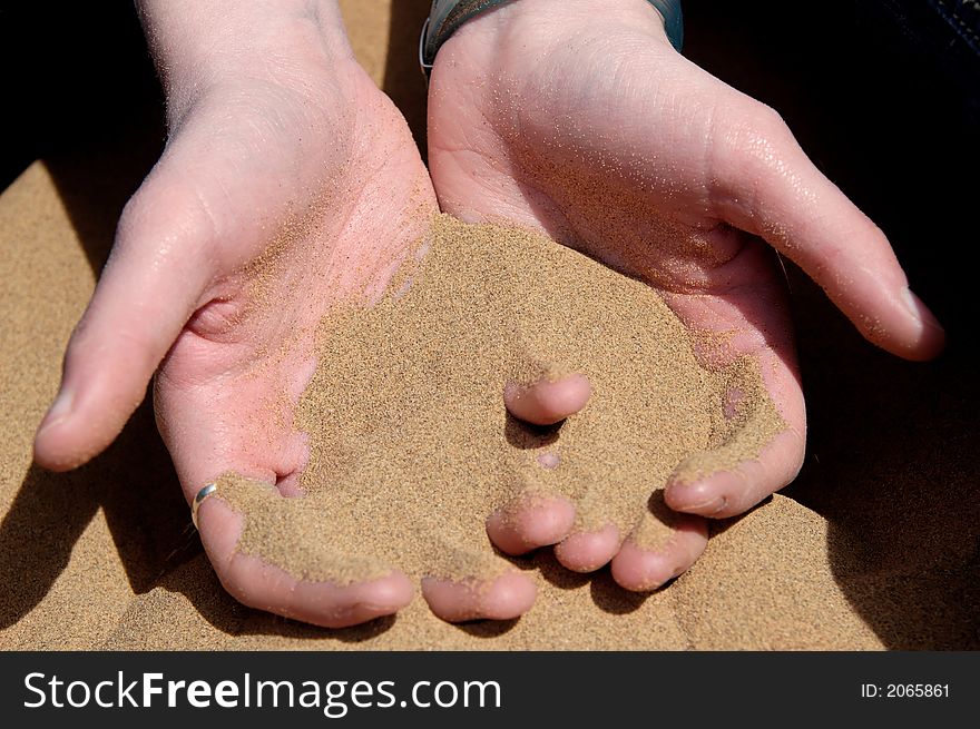 Image of sand flowing from hands. Image of sand flowing from hands.