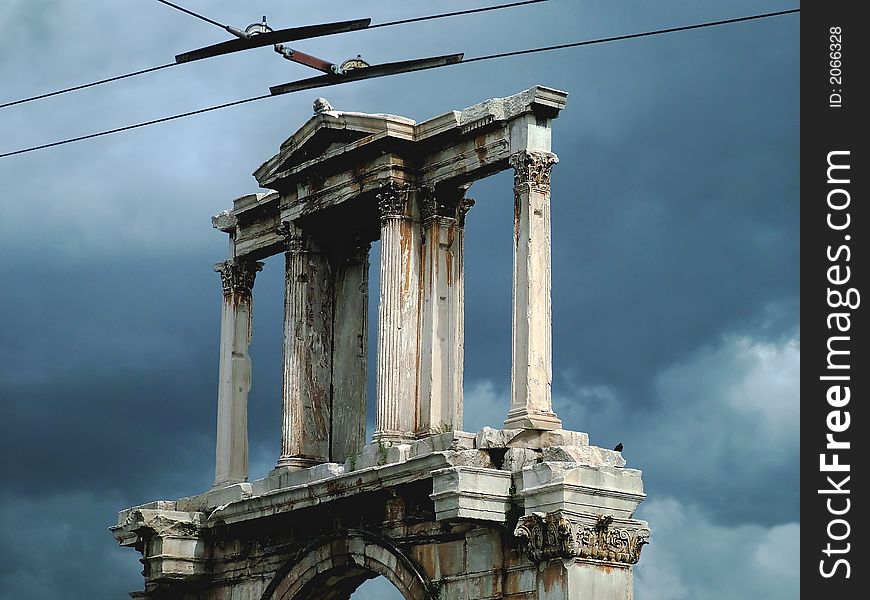 The temple of Zeus, ancient God. Above, overhead wires from a trolley bus.