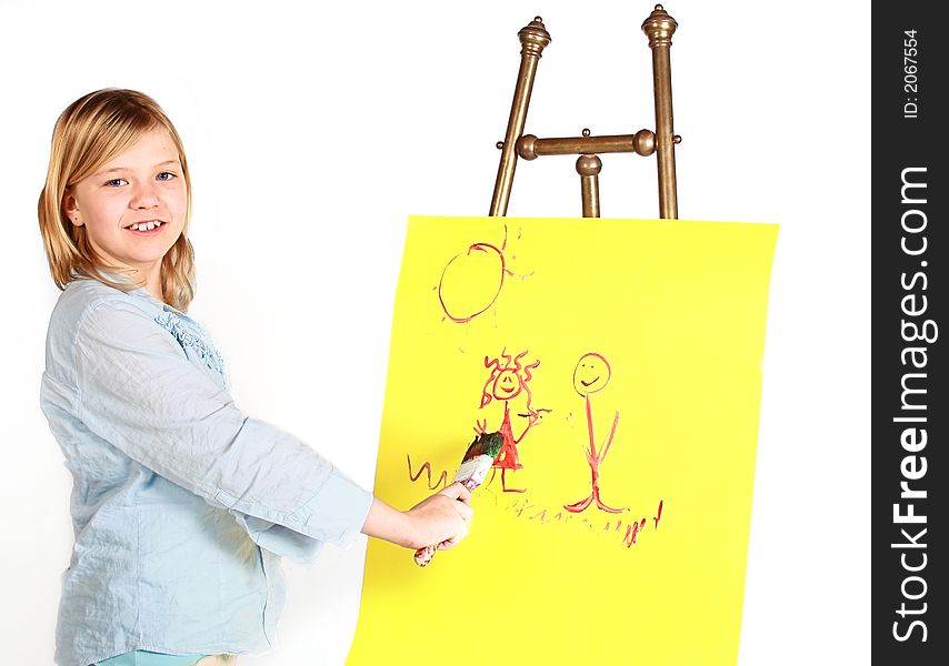 Pretty young girl painting on an antique easel. Pretty young girl painting on an antique easel