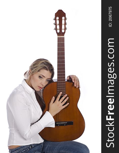 Girl guitarist holding guitar and thinking on a white background. Girl guitarist holding guitar and thinking on a white background