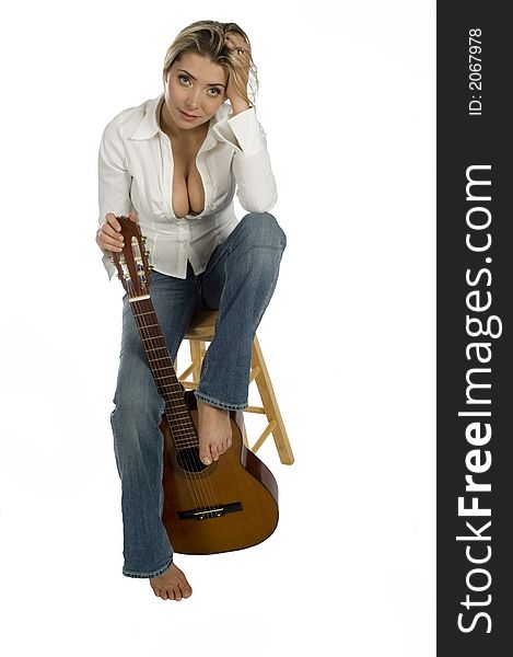 Female Guitarist Sitting On Stool Smiling