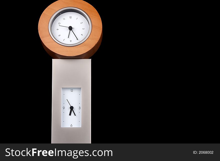 Two clocks stacked on each other against a black background.