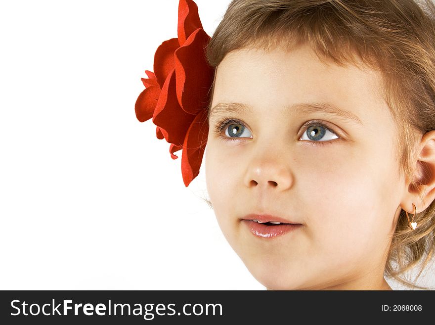 Little smiling girl with red rouses in the hair. Little smiling girl with red rouses in the hair