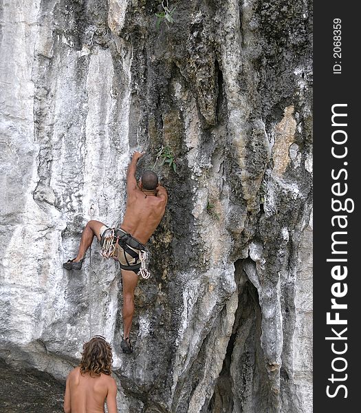 Men rock  climbing limestone thailand