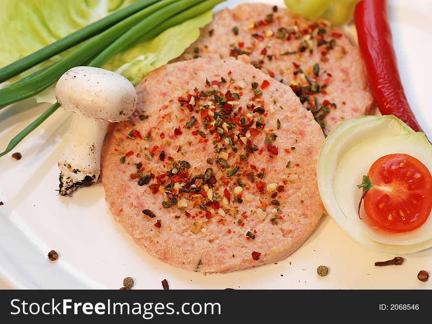 Hamburger with vegetables arrangement on plate