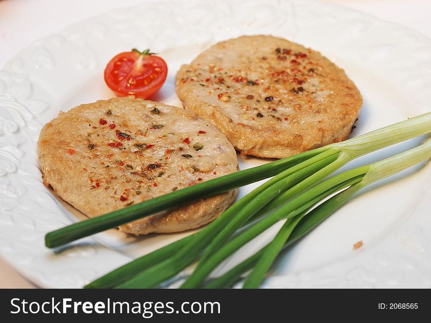 Two hamburgers with onion and tomato