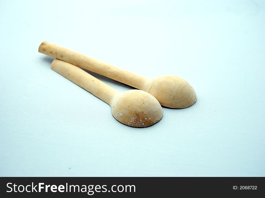 Two wooden spoon on a white background