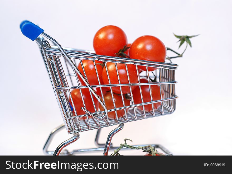 Shopping cart with tomato close up. Shopping cart with tomato close up