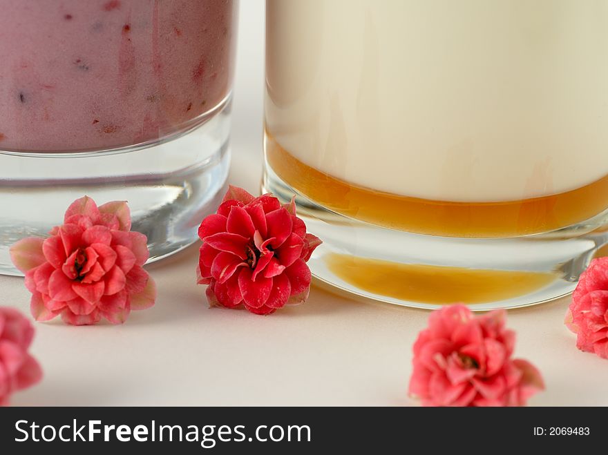 Macro of detail of milk beverage with flowers as deco