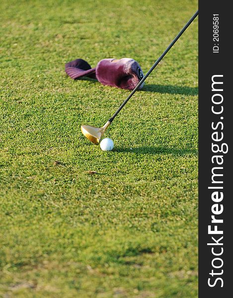 Closeup of club head as Golfer adjusting position of ball. Closeup of club head as Golfer adjusting position of ball