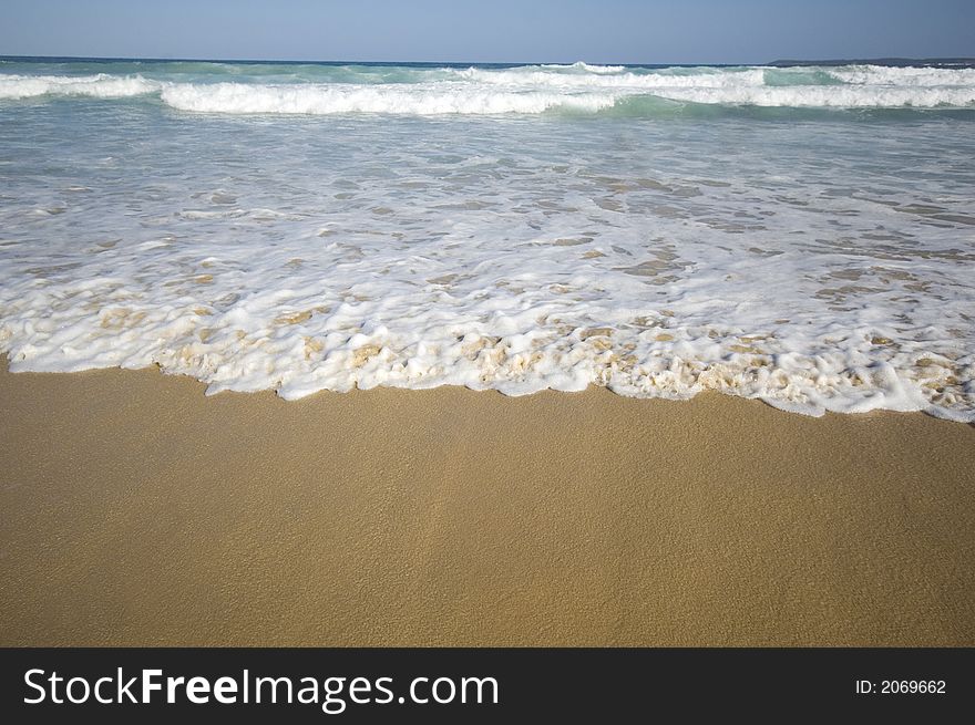 Closeup view of waves crashing on a tropical beach. Closeup view of waves crashing on a tropical beach