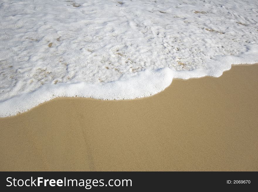 Closeup view of waves crashing on a tropical beach. Closeup view of waves crashing on a tropical beach