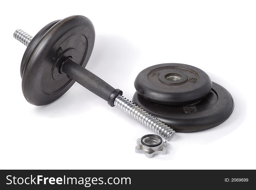 Partially disassembled black rubber dumbbell over white background. Partially disassembled black rubber dumbbell over white background