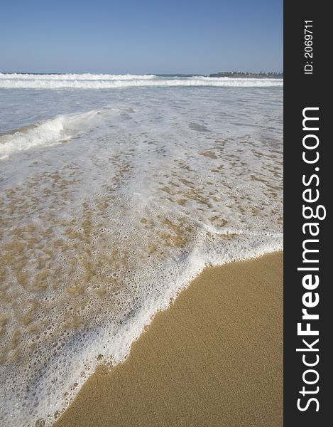 Closeup view of waves crashing on a tropical beach. Closeup view of waves crashing on a tropical beach