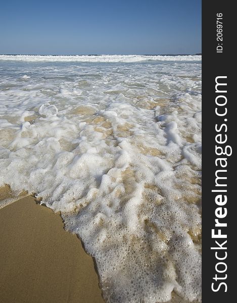 Closeup view of waves crashing on a tropical beach. Closeup view of waves crashing on a tropical beach