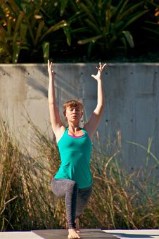 Woman Doing Yoga Outdoors In Warrior One Pose Royalty Free Stock Photos