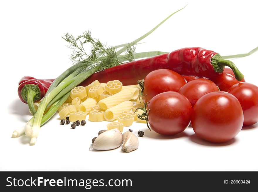 Tomatoes and pasta with spice on white background