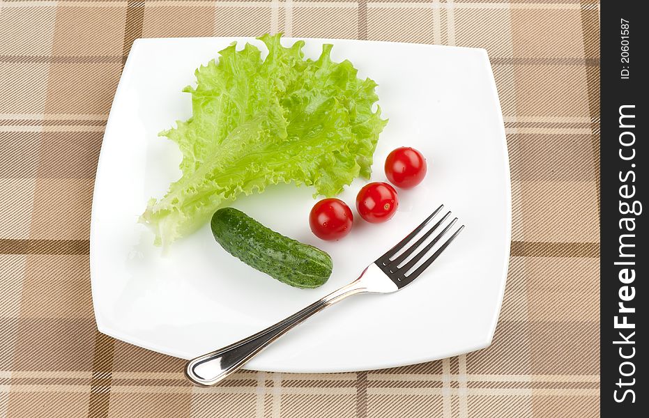 Fresh vegetables and green salad on a plate