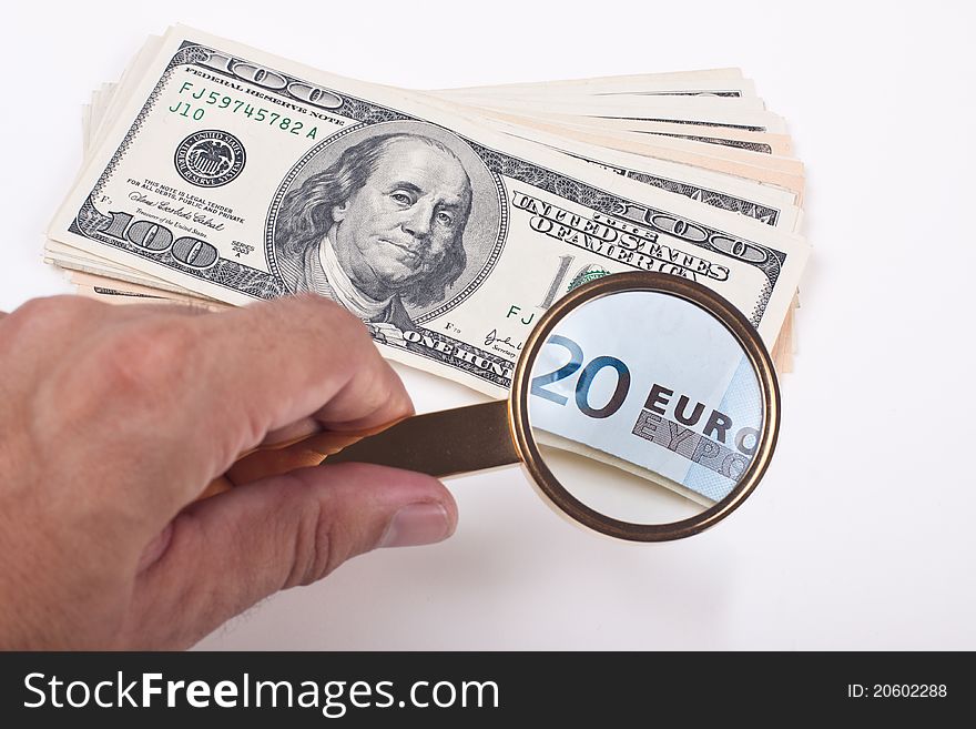 Magnifying a hundred dollar bill with golden color lupe showing 20 euro bill on white background. Magnifying a hundred dollar bill with golden color lupe showing 20 euro bill on white background