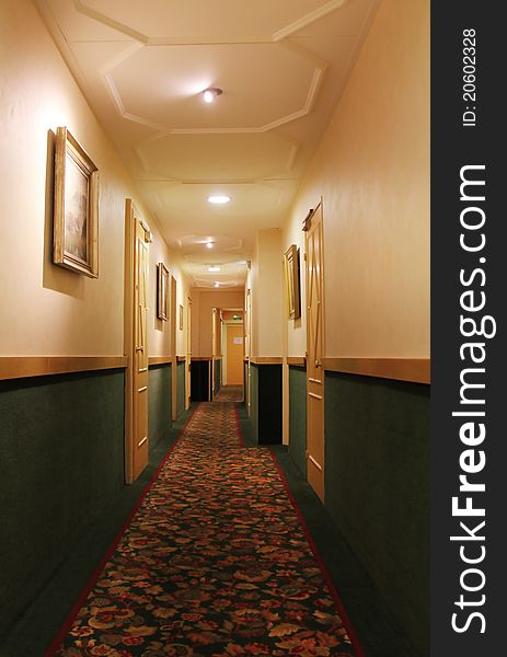 Hotel corridor with lamps on the ceiling