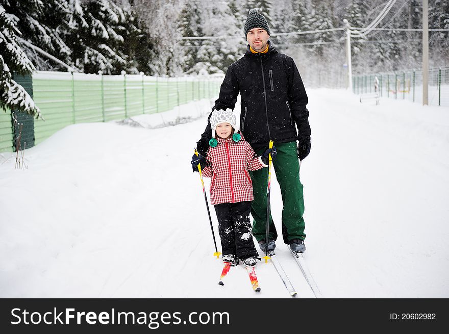 Young Father And Daughter Do Nordic Skiing