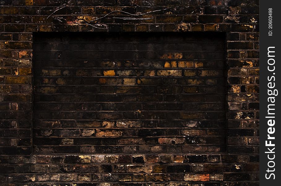 Old weathered brick wall, rectangular recess. Old weathered brick wall, rectangular recess