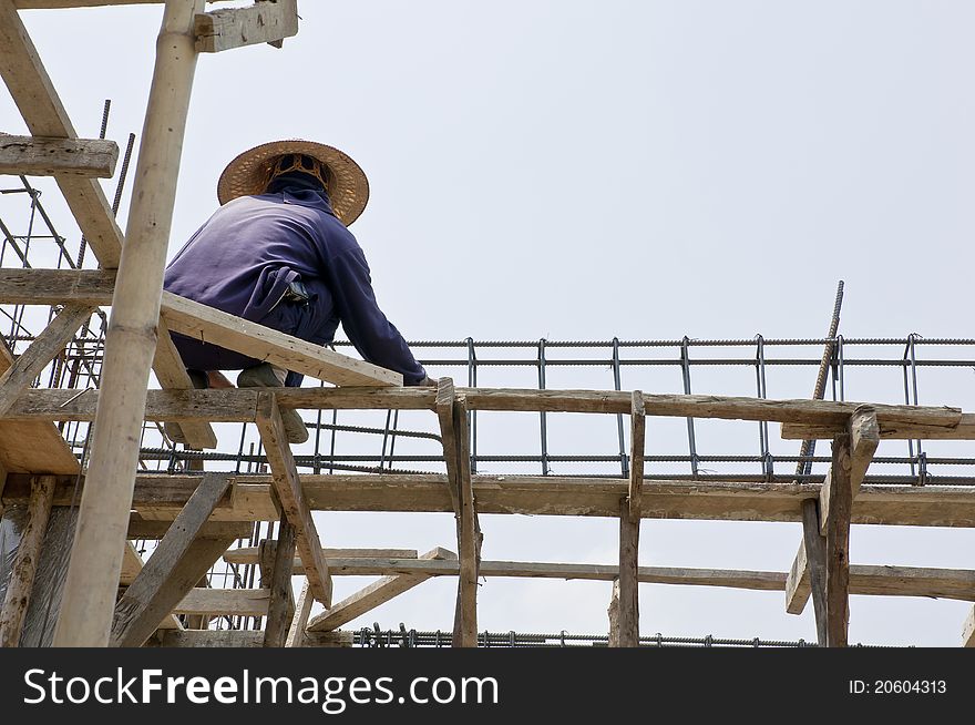 Thai laborers working on the scaffolding. Thai laborers working on the scaffolding.