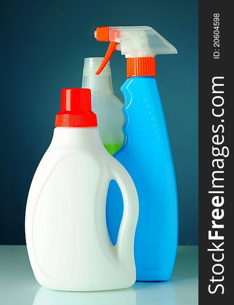 Detergent in a bottle with a blue background. Detergent in a bottle with a blue background