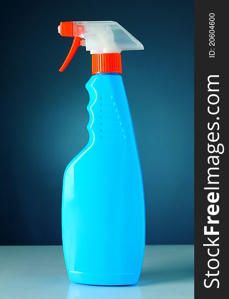 Detergent in a bottle with a blue background. Detergent in a bottle with a blue background