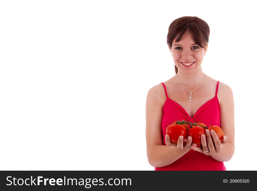 The pretty young woman holding tomatoes in her hand. The pretty young woman holding tomatoes in her hand